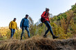 © Bisual Studio/Stocksy - Three friends Walking through the mountain in autumn