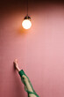 © ulas & merve/Stocksy - woman with green outfit in a pink room