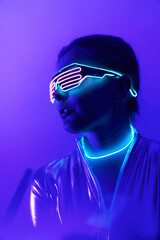 Cyberpunk style portrait of beautiful young woman in futuristic costume.