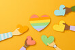 © Maki Company Limited/Stocksy - Many hands holding the heart around rainbow colorful heart LGBT flag