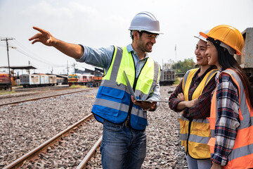 engineers working on railway train statation and holding laptop for plan and meeting. portrait of pr