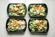 © Ali Harper Photography/Stocksy - Four salad containers prepped for healthy meal planning