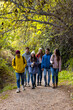 © Bisual Studio/Stocksy - Group of friends Walking On Path In the Woods