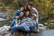 © Bisual Studio/Stocksy - Portrait of a group of friends by the river