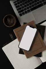 Wall Mural - Blank screen mobile cellphone, laptop, notebook, stationery on black background. Flat lay, top view minimalist aesthetic lifestyle blog, web, social media template. Copy space mockup.
