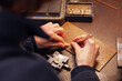 © Andrew Urwin/Stocksy - A small piece of jewellery is being hand made