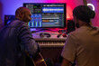 © MyMicrostock/Stocksy - Musicians producing music in home recording studio