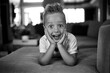 © Jakob Lagerstedt/Stocksy - Cute young boy with a crazy hairdo laying on a couch