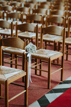 Rows Of Chairs In Church With Flower Bouquet