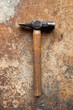 © Andrew Urwin/Stocksy - A hammer seen on an old wooden workbench
