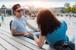 © shangarey - stylish young couple has fun chatting in a city park in the summer at sunset.