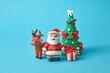 © Yaroslav Danylchenko/Stocksy - Craft plasticine Santa Claus with deer, tree and gifts.