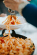 © Melissa Milis Photography/Stocksy - Scooping tagliatelle