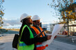 © Jimena Roquero/Stocksy - Woman engineer supervising the development of a building in construction with a foreman constructor.