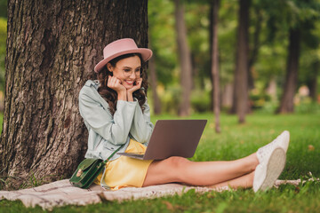 Sticker - Photo of adorable cute lady wear turquoise jacket spectacles handbag sitting green grass looking computer outside city park