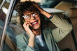 © Studio Firma/Stocksy - A Woman in the Car Talking on the Phone