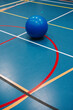 © Melissa Milis Photography/Stocksy - Flooring of a sports hall with different kind of lines and blue yoga ball
