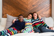 © Jennifer Bogle/Stocksy - Children sit together on a bed