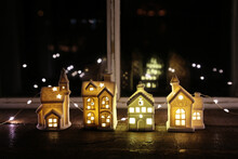 Row Of Lot Houses On Window Sill At Night