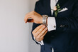 © Melissa Milis Photography/Stocksy - Man in suit adjusting watch