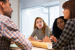© MyMicrostock/Stocksy - Multiethnic group of business people working in an office