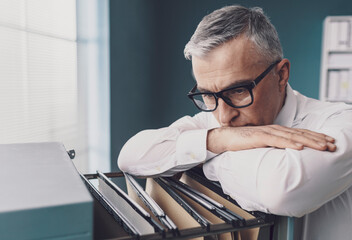 Businessman searching for files in the office