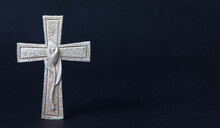Religious Celitic Cross With A Lily Decorated With On A Dark Background.
Moment Of Mourning At The End Of A Life. Last Farewell. Funeral Concept. Lots Of Copy Space For Religious Sayings.