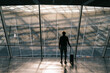 © Alina Hvostikova/Stocksy - Anonymous traveler standing near window in airport