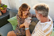 © Ivan Gener/Stocksy - Mature couple toasting with drinks on a patio