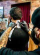 © Marco Govel/Stocksy - Tatoo artist working
