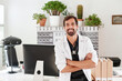 © Ivan Gener/Stocksy - Smiling young doctor standing in his office