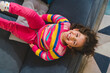 © Giorgio Magini/Stocksy - Happy Little Girl Upside Down on Sofa