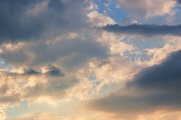 Wall Mural - clouds in idyllic evening light. nature background in warm yellow and orange tones