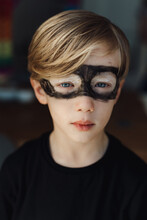 Portrait Of A Sad Boy With Super Hero Mask