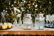 © Melissa Milis Photography/Stocksy - lemonade jars with dispenser on a rustic wooden table