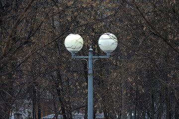 a lamp with two plafonds among the trees