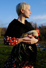 Girl Standing With The Rooster