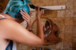 © Eloisa Ramos/Stocksy - Young woman dyeing her hair blue at home