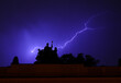 © Amos Chapple/Stocksy - Lightning flashes behind a 19th-century statue in Prague.
