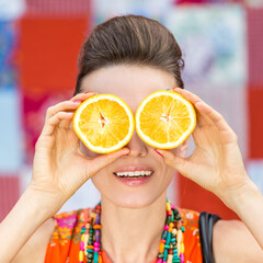 woman holding oranges 