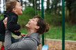 © Rob and Julia Campbell/Stocksy - Mom hugging kid with love and joy and the park