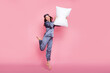 Full length body size photo of girl in sleepwear laughing fighting with pillow on pajama party isolated on pastel pink color background