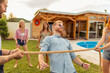 © Impact Photography - Friends dancing limbo at summertime party