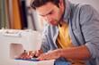 © Monkey Business - Close Up Of Male Student Or Business Owner Working In Fashion Using Sewing Machine In Studio