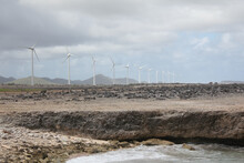 Row Of Wind Turbines Along The Coast Of Bonaire In The Caribbean On A Cloudy