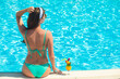 © el.rudakova - Young woman sitting in the pool in luxury resort,