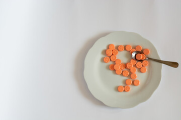 Pills, vitamins, medicine on a plate.