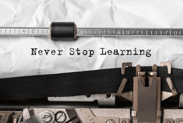 Wall Mural - text never stop learning typed on retro typewriter