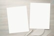 Stationery mockup, two empty writing paper sheets on white wooden background, blank letters and envelope.