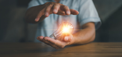 Poster - businessman holding light bulb, creative new idea. innovation, brainstorming, inspiration and soluti